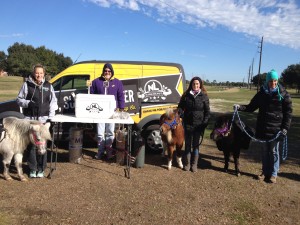 While walking the course at Willow Fork, SIRE's minis and their handlers stop to visit sponsor, No Label Brewery.